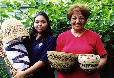 Avis Punkin (right) and her granddaughter and 2003 apprentice Carly Tex holding baskets made by Avis.