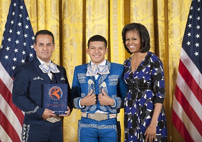 Artist Instructor Sergio Alonso (left), youth recipient Ernesto Lazaro, and First Lady Michelle Obama.