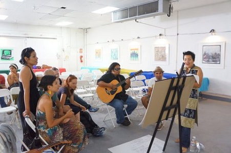 Martha Gonzalez (right, standing), lead singer of the band Quetzal, leads a collective songwriting workshop.