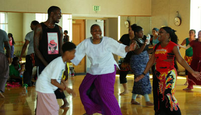 A typical class includes many ages and abilities.  Here Naomi and son Ibrahim improvise with students.