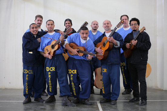 Quetzal Flores (midddle back) and Cesar Castro (far right) with participants in their son jarocho workshops taught at Corcoran State Prison from September-December 2014.