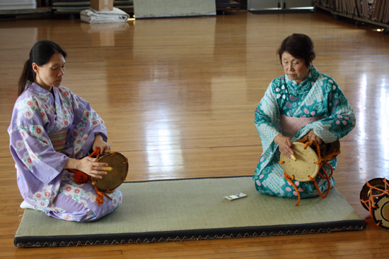 Master artist, Kimisen Katada (Mariko Watabe) of Japanese Hayashi classical percussion, leads her apprentice Amy Smith through some musical exercises on the ōtsuzumi drum.