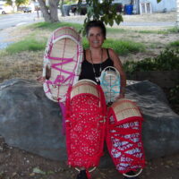 Beverly Cantrell holding baskets made for her grandchildren. Photo taken by her son Lew George.