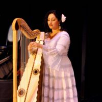 Nydia playing traditional Mexican harp
