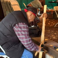 Teaching use of carving tool. Photo taken by Willie Carrillo Sr