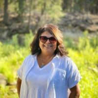 Mary in Yosemite standing among dogbane