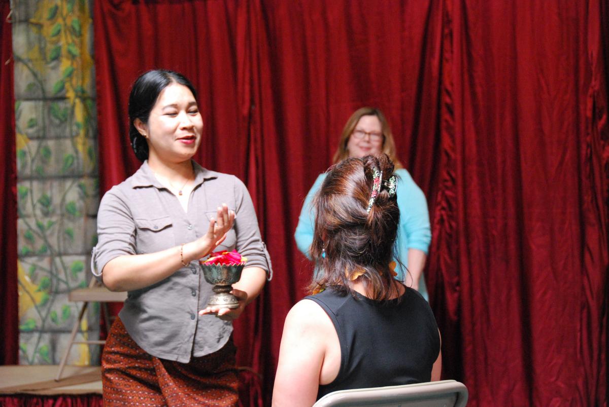 Bay Area Cambodian Classical Dancer Charya Burt gives Lily a traditional blessing as Director Amy Kitchener looks on.
