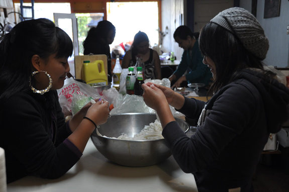 Food preparation is followed by a shared meal and storytelling sessions, where both the community elders and young women are encouraged to share.