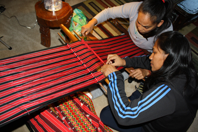 Master weaver Jenny Bawer Young (right) will work with LAGA, California Circle, this year to continue the training of a group of apprentices in laga, the traditional Kalinga backstrap weaving of this indigenous peoples of the Philippines.