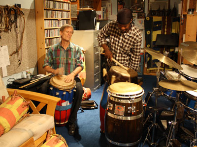 Kendrick (left) playing a petwo drum and Daniel playing the manman of the rada drum family.