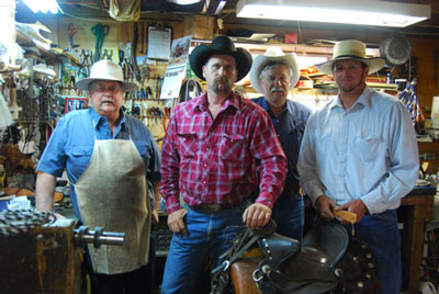 Master saddlemaker Garry McClintock and his 2010 apprentice Ronald Titus with two local customers in McClintock Saddleworks