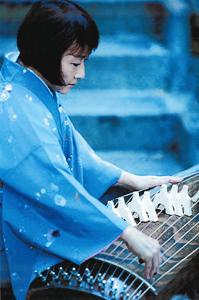 Master artist Shirley Kazuyou Muramoto plays the koto, a traditional Japanese 13-stringed zither