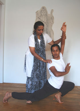 Prakash refines Aysola’s posture before a drawing of Lord Krishna in Prakash’s studio.