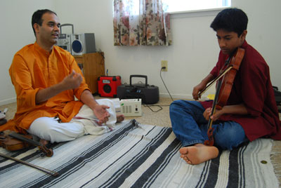 Master artist Parasuraman SunderRajan (left) instructs apprentice Kiran Athreya during one of their lessons in Carnatic violin.