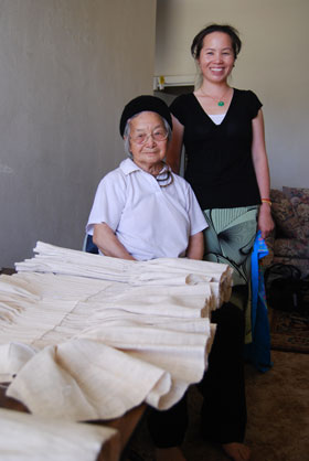 Master textile artist Ju Yang and her daughter-in-law and 2008 apprentice Pao Ge Vue, with the tiab dawb (a hand-pleated, hemp cermonial skirt) that was completed as part of theri apprenticeship.